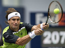 David Ferrer stretches to reach a backhand