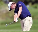 Webb Simpson hits out of a bunker on the seventh fairway