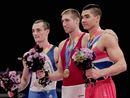 Cyril Tommasone, Krisztian Berki and Louis Smith stand on the podium after the men's apparatus finals