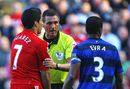 Andre Marriner talks with Patrice Evra and Luis Suarez 