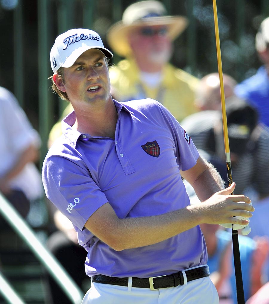 Webb Simpson watches his shot off the first tee