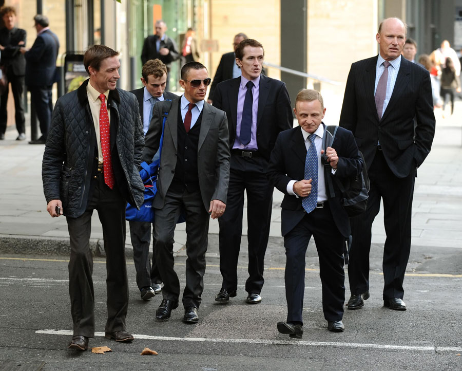 Jockeys arrive at the BHA headquarters in London
