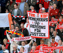 A Liverpool fan holds up a banner in memory of the Hillsborough disaster
