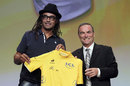 Yannick Noah and Bernard Hinault show off the new yellow jersey for the 2012 Tour de France
