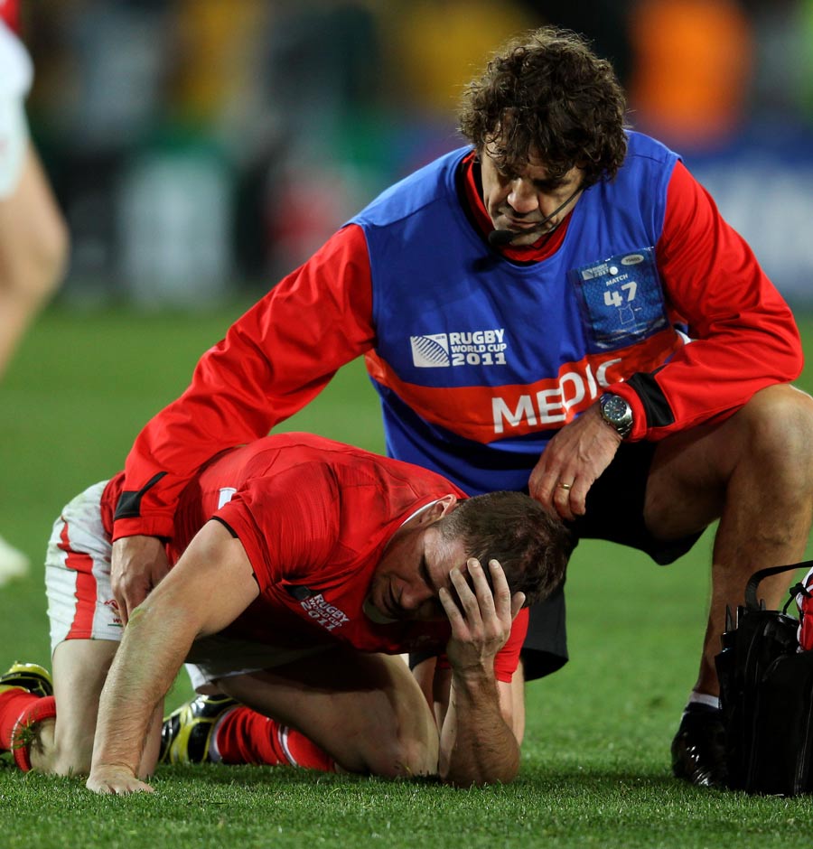 Shane Williams lies dejected as he is comforted by team physio Mark Davies
