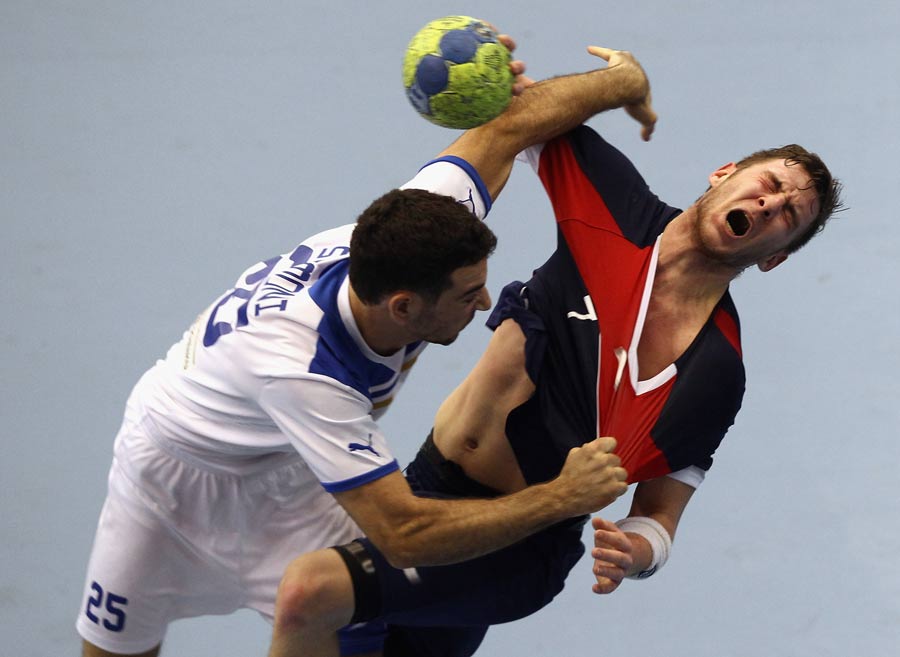 Chris Mohr of Great Britain clashes with Tomer Shimoni of Israel during the men's handball Euro 2012 qualifier