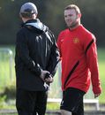 Wayne Rooney talks with Sir Alex Ferguson during a training session