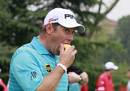 Lee Westwood bites into an apple