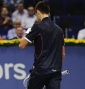 Novak Djokovic walks back to his seat against Marcos Baghdatis
