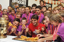 Roger Federer celebrates his victory with the ball boys and girls