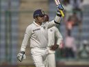 Virender Sehwag raises his bat after scoring fifty runs