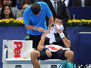 Novak Djokovic receives treatment on a shoulder injury