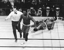 Joe Frazier is directed to the ropes by referee Arthur Marcante after knocking down Muhammad Ali