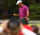 Tiger Woods inspects his ball