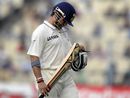 Sachin Tendulkar looks at his bat after losing his wicket