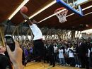 LeBron James slam dunks for fans at a Nike event