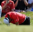 Tiger Woods reacts to missing a putt for birdie on the 18th hole 