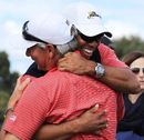 Tiger Woods embraces captain Fred Couples