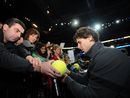 Rafael Nadal signs autographs after beating Mardy Fish