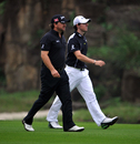 Graeme McDowell and Rory McIlroy stride down the fairway