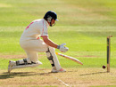 Michael Powell can't stop the ball rolling back into his stumps on 99
