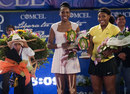 Venus and Serena Williams pose with their prizes
