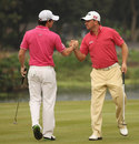 Rory McIlroy and Graeme McDowell celebrate making a birdie