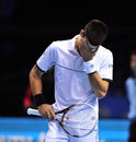Novak Djokovic holds his head in his hands