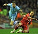 James Milner and Lucas Leiva challenge for the ball
 
