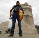 Amir Khan poses with his belts in front of the Martin Luther King Jr Memorial