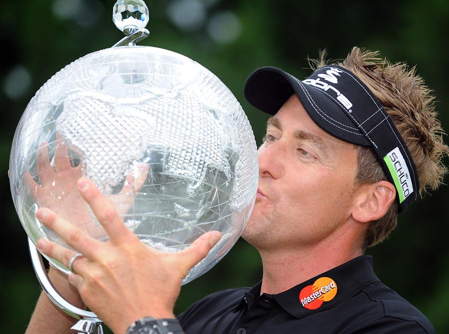 Ian Poulter holds the winners trophy