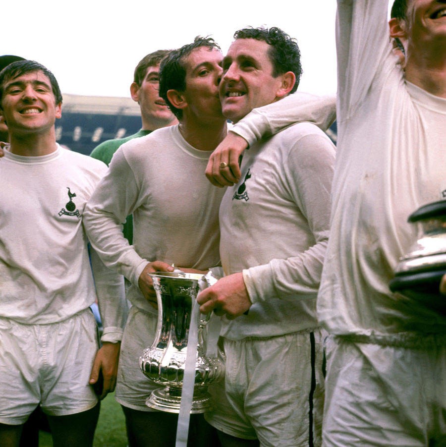Tottenham player Terry Venables looks pleased as team-mate Alan Mullery kisses Dave Mackay