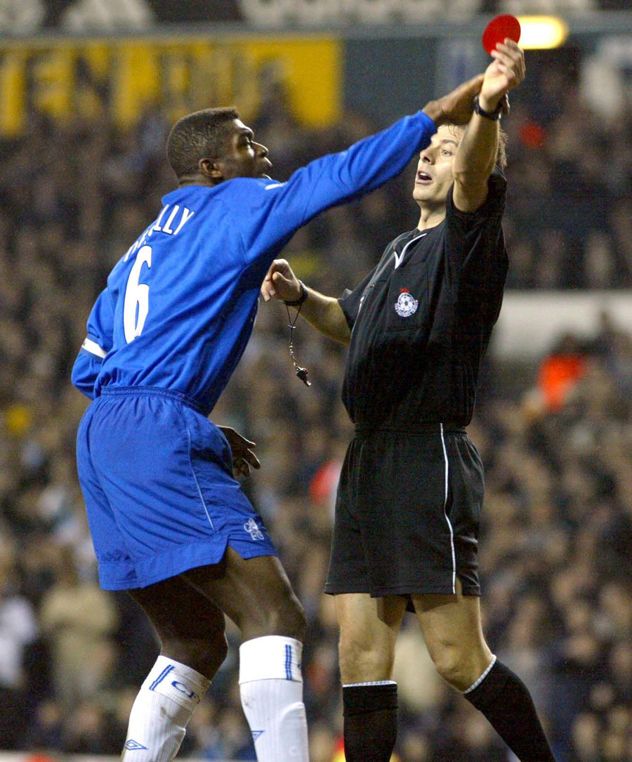 Chelsea's Marcel Desailly attempts to stop Mark Halsey waving a red card