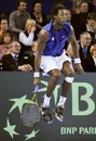 Gael Monfils jumps to return the ball