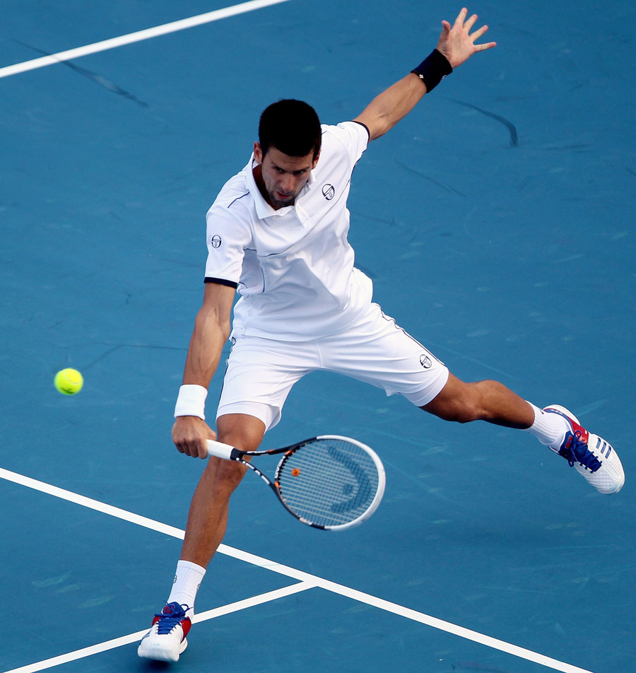 Novak Djokovic plays a volley