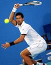 Novak Djokovic returns a forehand