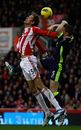 Peter Crouch and Gary Caldwell compete for a high ball