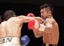 Takashi Uchiyama receives a punch from Jorge Solis