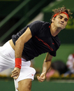 Roger Federer tracks his serve