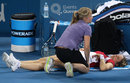 Kim Clijsters receives treatment on a hip injury