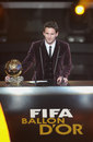 Lionel Messi poses with his Ballon d'Or