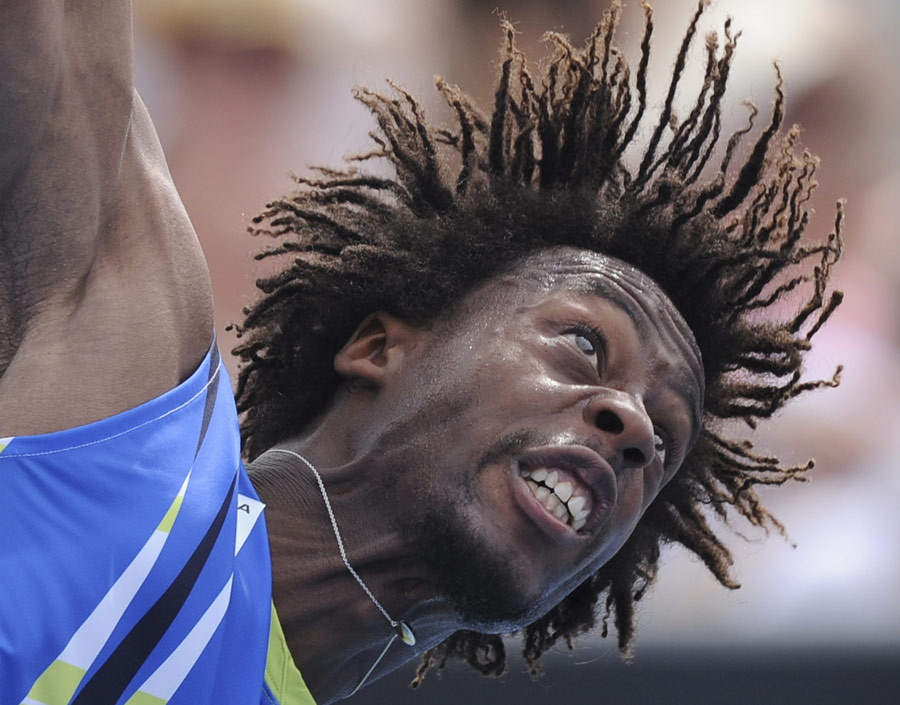 Gael Monfils stretches for a serve