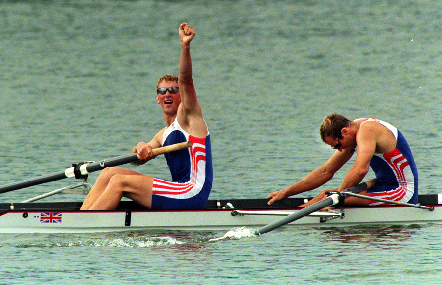 Matthew Pinsent celebrates as Steve Redgrave crumples after winning the coxless pairs