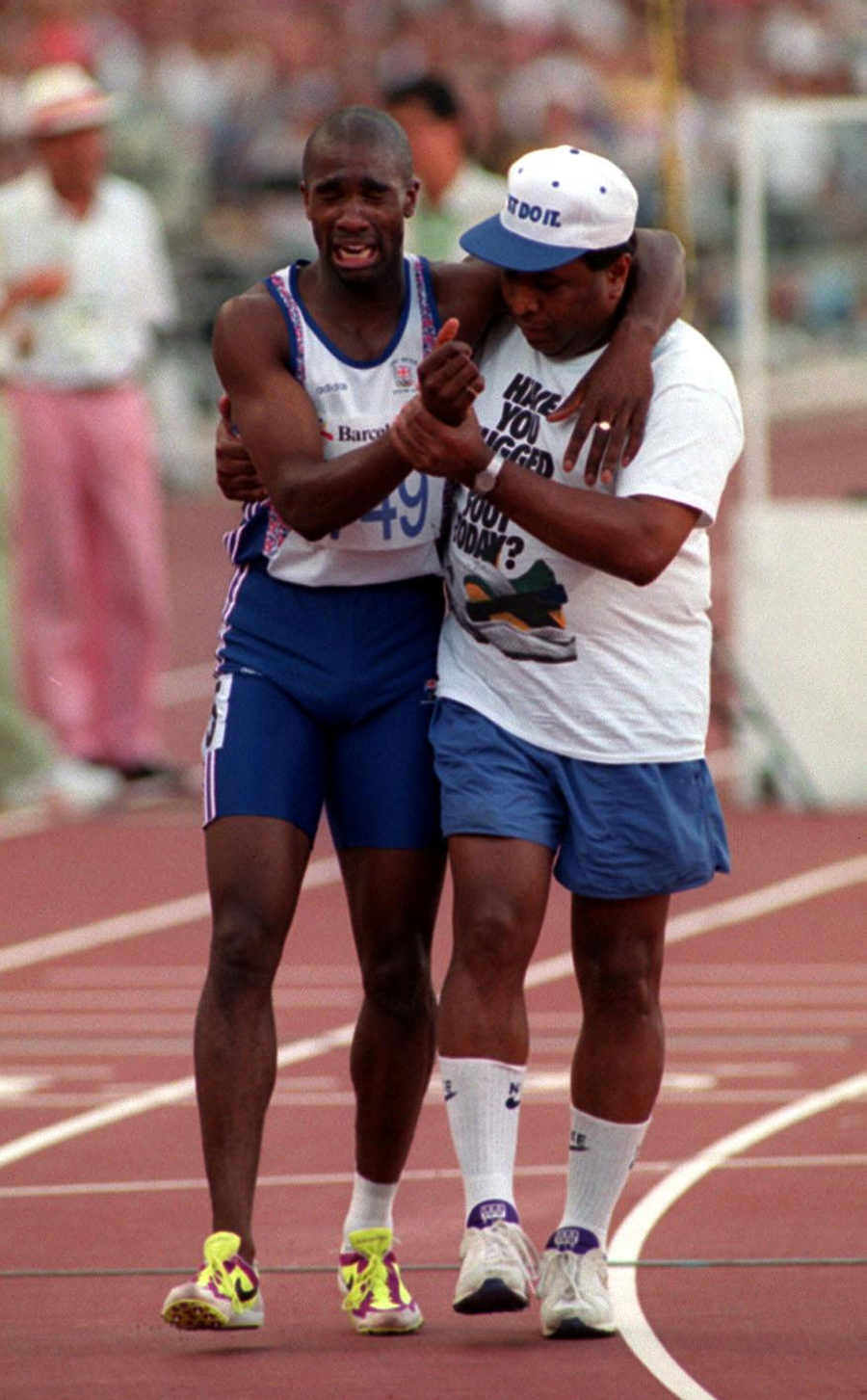 A striken Derek Redmond is helped to the finish line by his father Jim