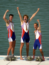 Rowers Tom and Greg Searle and cox Garry Herbert punch the air after collecting their gold medals