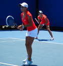 Laura Robson waits to receive serve while partner Ashley Barty looks on