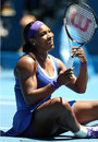 Serena Williams laughs after falling