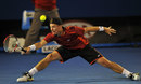 Lleyton Hewitt stretches for a forehand