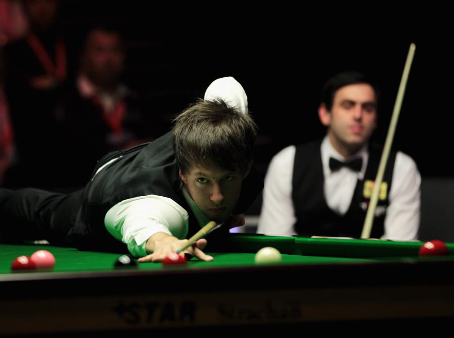 Judd Trump is watched by Ronnie O'Sullivan