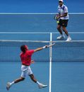 Roger Federer volleys against Ivo Karlovic